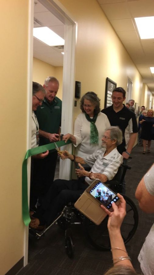 Chaplain Michael Fronk Cutting the ribbon to the Fronk Offense Staff Room. Photo courtesy of Deanna Harrison.